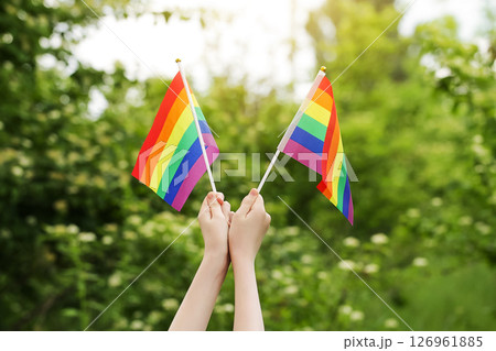 Teenager Holds Two Rainbow Flag LGBT in his Hands. Pride Month. Lesbian Gay Bisexual Transgender. Love, human rights, tolerance 126961885