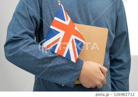 Learn English language, Asian teenage student hold book with flag in course at school. Learn English language, Asian teenage student hold book with flag in course at school. 126962712