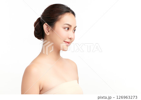 A beautiful young Asian woman with clean, fresh skin against a white background. Skincare, facial treatment, cosmetology, beauty, and spa. An elegant portrait of an Asian woman. 126963273