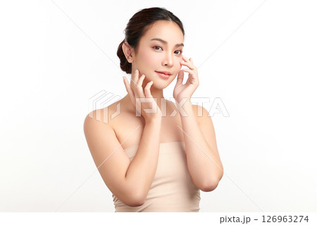 A beautiful young Asian woman with clean, fresh skin against a white background. Skincare, facial treatment, cosmetology, beauty, and spa. An elegant portrait of an Asian woman. 126963274