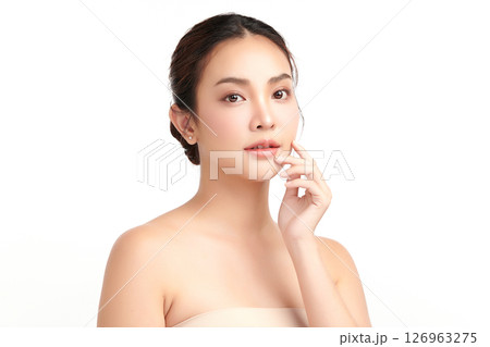 A beautiful young Asian woman with clean, fresh skin against a white background. Skincare, facial treatment, cosmetology, beauty, and spa. An elegant portrait of an Asian woman. 126963275