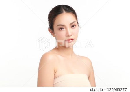 A beautiful young Asian woman with clean, fresh skin against a white background. Skincare, facial treatment, cosmetology, beauty, and spa. An elegant portrait of an Asian woman. A beautiful young Asian woman with clean, fresh skin against a white background. Skincare, facial treatment, cosmetology, beauty, and spa. An elegant portrait of an Asian woman. 126963277