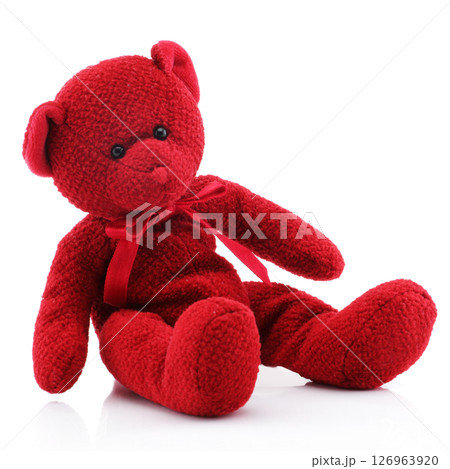 Red teddy bear sitting on white 126963920