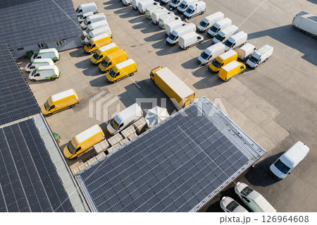 Delivery vans and trucks hub with solar panels on a roof. Fleet of vehicles 126964608