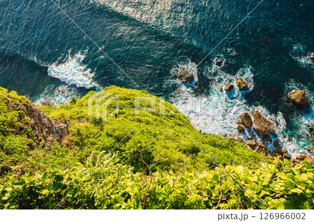 Ocean with waves crashing on rocks stones, view from high rocky coastline Ocean with waves crashing on rocks stones, view from high rocky coastline 126966002