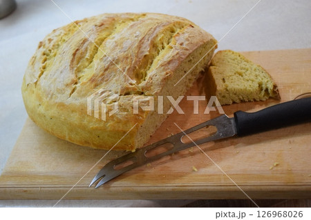 Freshly Baked Bread with Knife on Cutting Board Freshly Baked Bread with Knife on Cutting Board 126968026