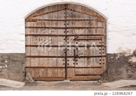 old big door with rusty iron strips old big door with rusty iron strips 126968267
