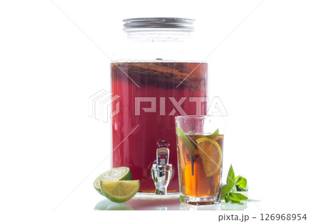 Golden kombucha with bubbles and greenery on white background Golden kombucha with bubbles and greenery on white background 126968954