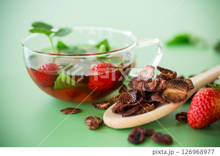 Aromatic herbal drink with berries on a green background 126968977