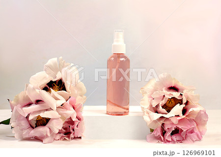 Spa salon advertising card. Wellness composition with lilac water and fresh mountain peony flowers, natural self-care and healthy lifestyle concept, abstract composition with flowers. Spa salon advertising card. Wellness composition with lilac water and fresh mountain peony flowers, natural self-care and healthy lifestyle concept, abstract composition with flowers. 126969101