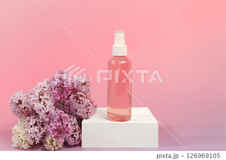 Advertising postcard of spa salon. Wellness composition with lilac water and fresh lilac flowers, Concept of natural self-care and healthy lifestyle, abstract composition with flowers. Advertising postcard of spa salon. Wellness composition with lilac water and fresh lilac flowers, Concept of natural self-care and healthy lifestyle, abstract composition with flowers. 126969105