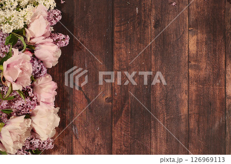 Beautiful spring blooming branches of lilac and mountain peony on sunny background. Abstract flower arrangement and banner for screen, Still life with place for text, Floral holiday card Beautiful spring blooming branches of lilac and mountain peony on sunny background. Abstract flower arrangement and banner for screen, Still life with place for text, Floral holiday card 126969113