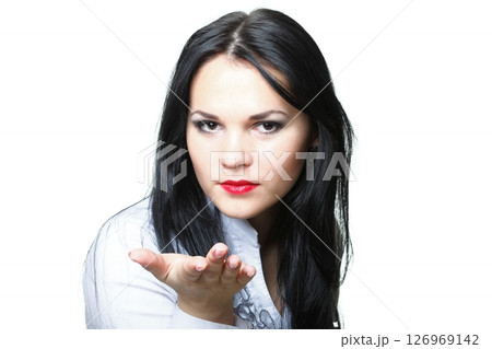 beautiful young woman blowing a kiss 126969142