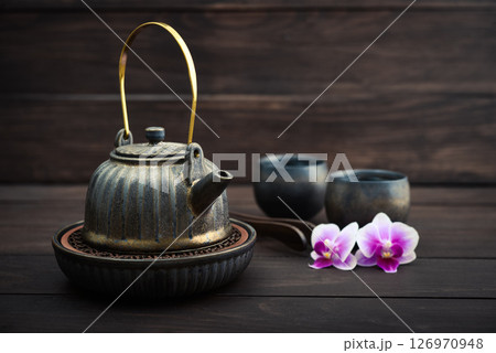 Traditional asian tea ceremony arrangement: ceramic teapot, cups and bamboo chaban Traditional asian tea ceremony arrangement: ceramic teapot, cups and bamboo chaban 126970948