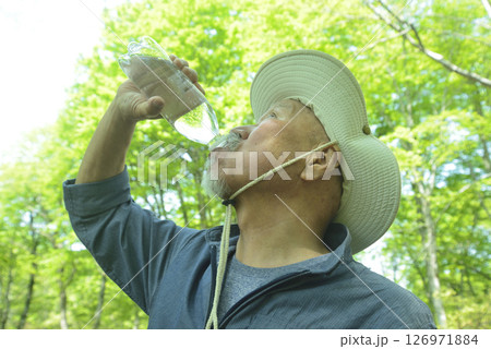 森林浴の老人が熱中症対策で水分補給 森林浴の老人が熱中症対策で水分補給 126971884