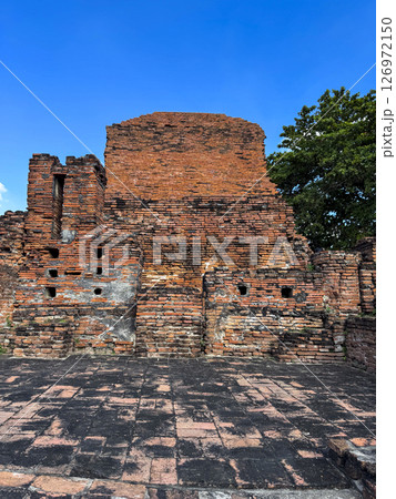 Majestic religious Thai landmark with many Buddha statues along the temple walls, Wat Maha That Buddhist ancient structure offer a serene sacred atmosphere. Cultural heritage monument. Majestic religious Thai landmark with many Buddha statues along the temple walls, Wat Maha That Buddhist ancient structure offer a serene sacred atmosphere. Cultural heritage monument. 126972150
