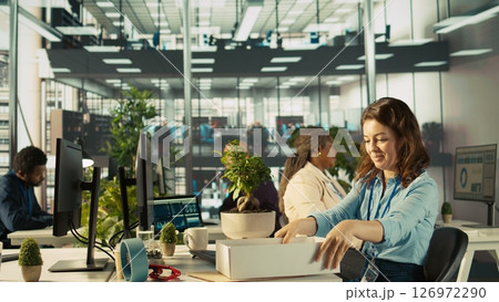 Happy employee starting first day at new job, unpacking belongings, meeting coworkers. Cheerful worker arriving in office, starting work on new company position, being welcomed by team, camera B 126972290