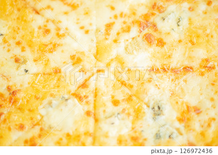 Four cheese pizza as a background macro photo. Four cheese pizza as a background macro photo. 126972436