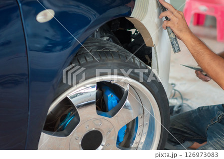 Checking car body work fiber bumper at car garage Checking car body work fiber bumper at car garage 126973083
