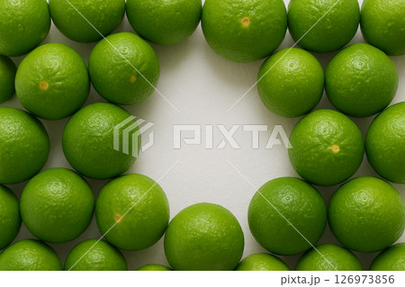 Fresh limes pile top view white center Fresh limes pile top view white center 126973856