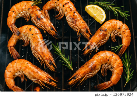 Grilled black tiger prawns on charcoal rosemary 126973924