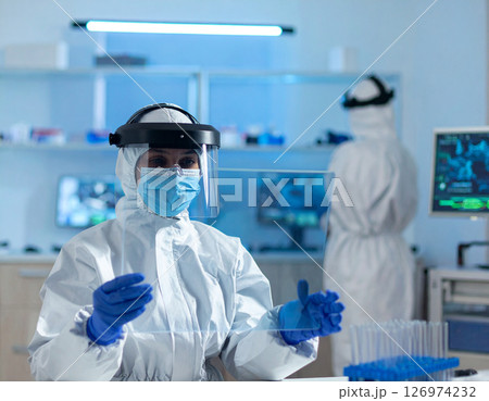 AI generated medical professional in white coat with VR glasses using transparent tablet showing glowing 3D brain hologram in clean hightech bluewhite setting 126974232