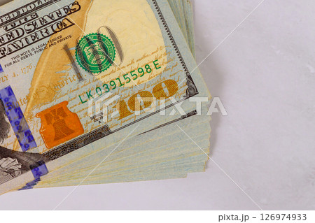 Stacks of USA hundred dollar bills highlighting intricate designs details of cash currency. Stacks of USA hundred dollar bills highlighting intricate designs details of cash currency. 126974933