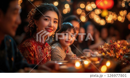 warm family gathering during Chinese New Year dinner, filled with joy, delicious food, and the glow of lanterns, celebrating traditions, unity, and the beauty of togetherness in a festive atmosphere. 126977801