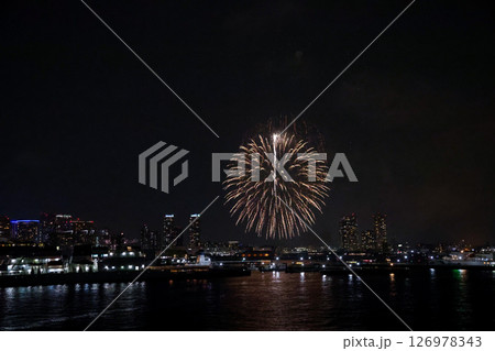 A vibrant city skyline at night near Yokohama Port with lights and boats 126978343