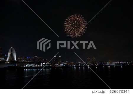 A vibrant city skyline at night near Yokohama Port with lights and boats A vibrant city skyline at night near Yokohama Port with lights and boats 126978344