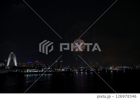 A vibrant city skyline at night near Yokohama Port with lights and boats A vibrant city skyline at night near Yokohama Port with lights and boats 126978346