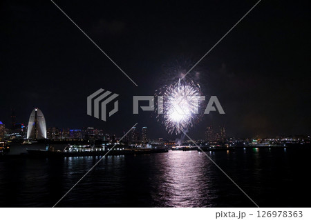 A vibrant city skyline at night near Yokohama Port with lights and boats 126978363