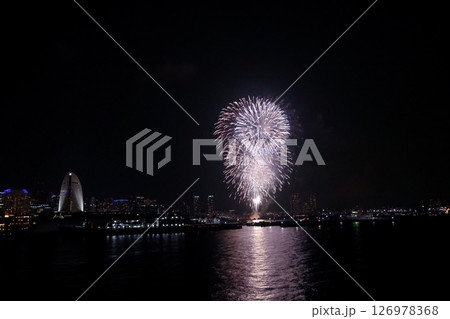 A vibrant city skyline at night near Yokohama Port with lights and boats A vibrant city skyline at night near Yokohama Port with lights and boats 126978368