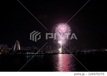 A vibrant city skyline at night near Yokohama Port with lights and boats A vibrant city skyline at night near Yokohama Port with lights and boats 126978370
