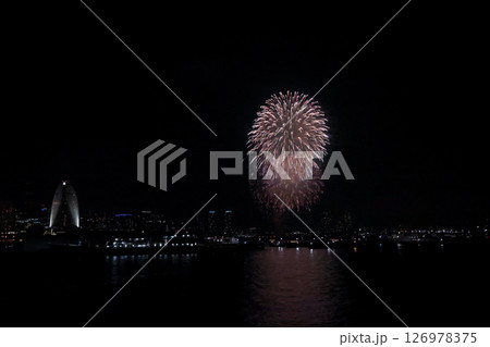 A vibrant city skyline at night near Yokohama Port with lights and boats A vibrant city skyline at night near Yokohama Port with lights and boats 126978375