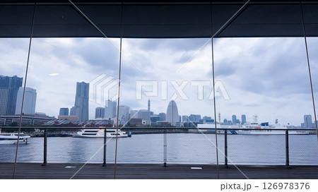 A vibrant city skyline at night near Yokohama Port with lights and boats A vibrant city skyline at night near Yokohama Port with lights and boats 126978376