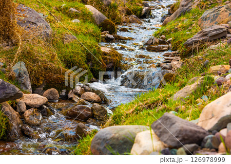 Clear stream flowing over mossy rocks. Clear stream flowing over mossy rocks. 126978999