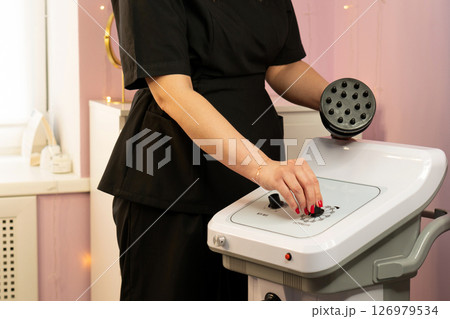 A therapist operating a multi-node attachment on a shaping device 126979534