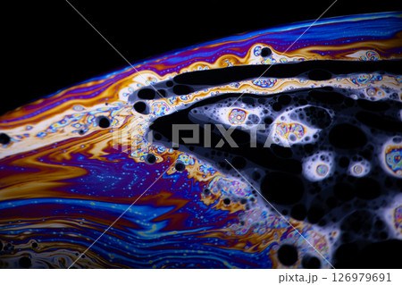 Macro photo of colourful pastel swirly patterns of a soap bubble Macro photo of colourful pastel swirly patterns of a soap bubble 126979691
