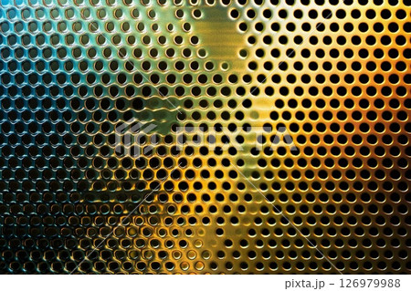 Colorful reflections on a metallic surface create an ethereal atmosphere in a dimly lit space 126979988