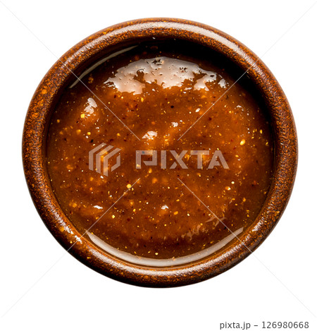 Rich and Spicy Brown Sauce in a Rustic Bowl on a Dark Background 126980668