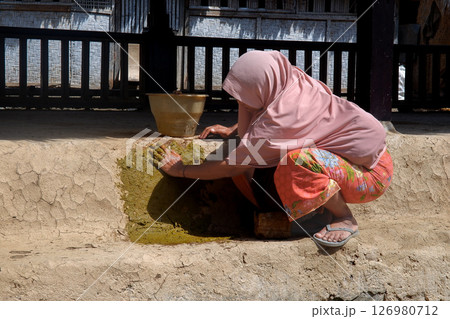Lombok, May 25, 2025, Sasak Ende village tradition of mopping the floor using cow dung 126980712