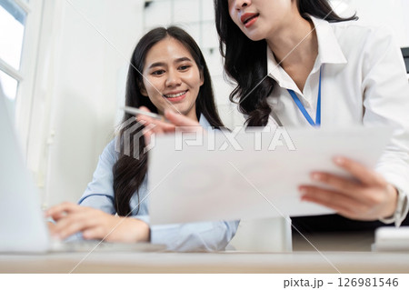 Professional Collaboration. Woman explaining project details to her colleague in an office. 126981546