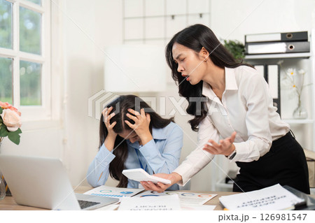 Workplace Conflict and Stress. Employee expressing frustration towards a colleague in an office setting. 126981547