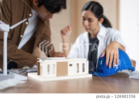 ESG Focused Design. Young professionals strategizing sustainable architecture solutions. 126981556