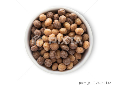 Top view bowl with healthy peanut butter puffs breakfast cereal on white.Macro. 126982132