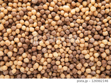 Mini peanut butter and chocolate puffs breakfast cereal textured macro shot.Top view. 126982146