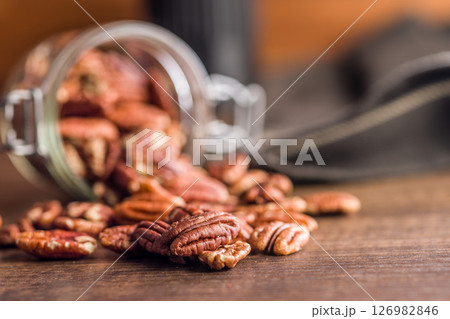 Peeled pecan nuts on wooden table. Peeled pecan nuts on wooden table. 126982846