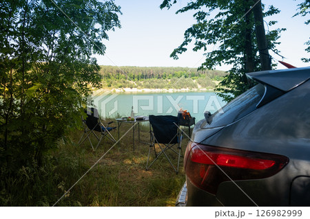 Lakeside Camping Retreat with Car and Chairs 126982999