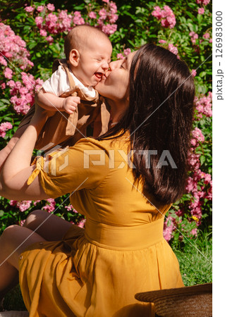 Joyful Mother and Baby in Blooming Garden 126983000